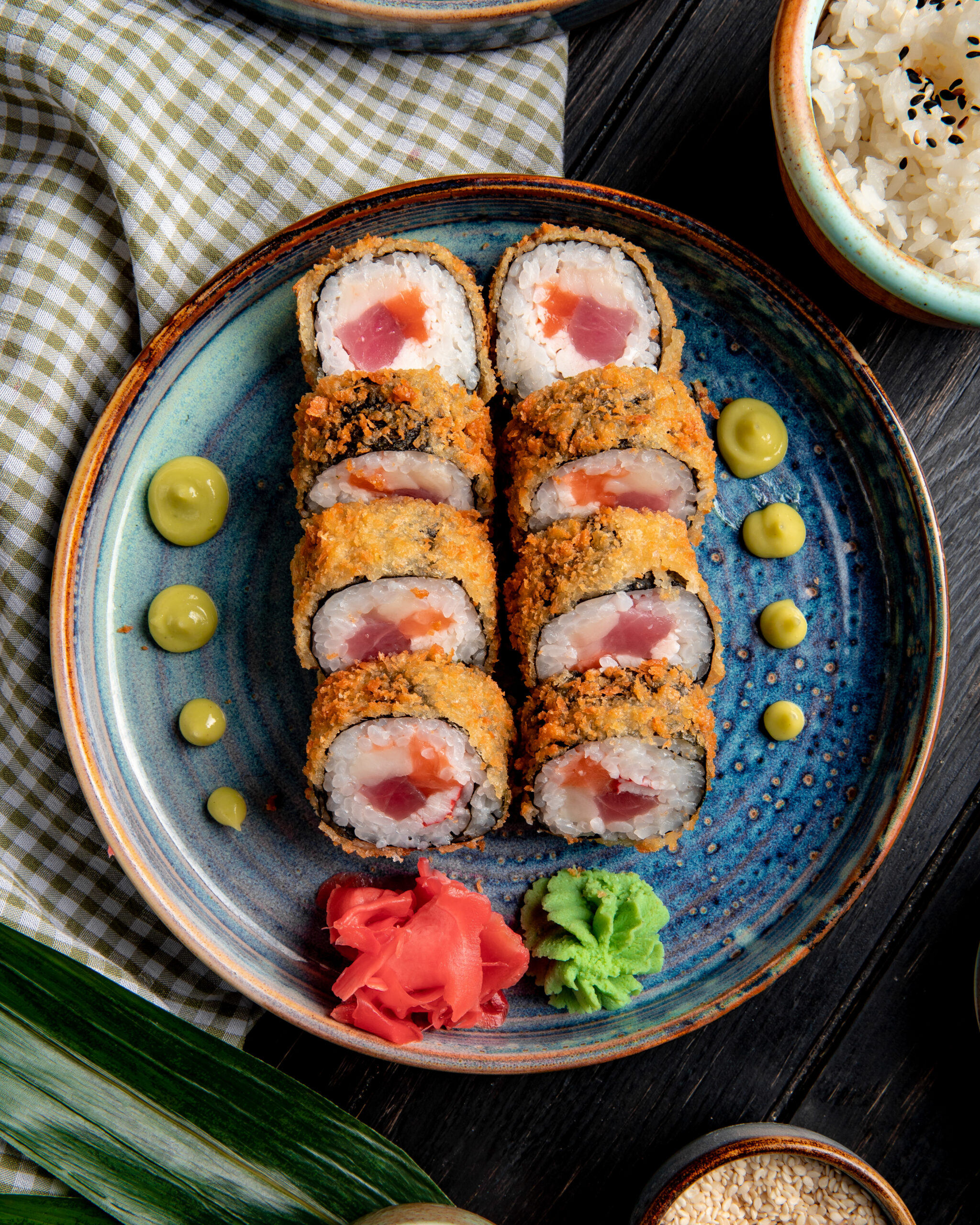 side-view-sushi-roll-with-crab-tuna-plate-with-ginger-wasabi-wood-scaled.jpg